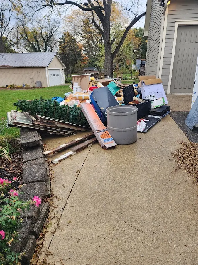 Dumpster being loaded with debris for Estate Cleanout Dumpster Rental in Topeka